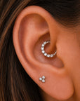 18k gold ear piercing jewelry with diamonds, featuring a huggie hoop and triple stud for elegant ear styling