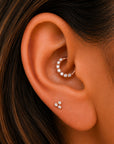 Rose gold ear piercing jewelry with diamond accents, featuring a hoop and stud set for elegant ear styling.