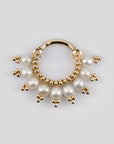 18k gold piercing ring with white pearls and floral detailing on a light background