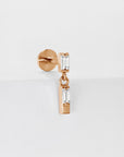 18k rose gold piercing with two baguette-cut clear gemstones, minimalist jewelry design