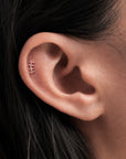 Delicate 18k gold ear piercing jewelry with geometric design, showcasing elegant body jewelry for a timeless look.