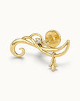 18k gold swirl piercing jewelry with a small diamond and dangling charm