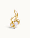 18k gold ear piercing jewelry featuring a white pearl and a sparkling diamond