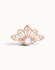 Rose gold crown-shaped piercing jewelry with a center white pearl on a white background