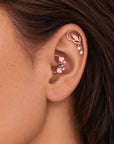 Rose gold leaf and pearl ear cuffs on a woman's ear