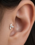 Delicate leaf-shaped 18k gold ear piercing with diamond accent, elegant fine jewelry for lobe piercings