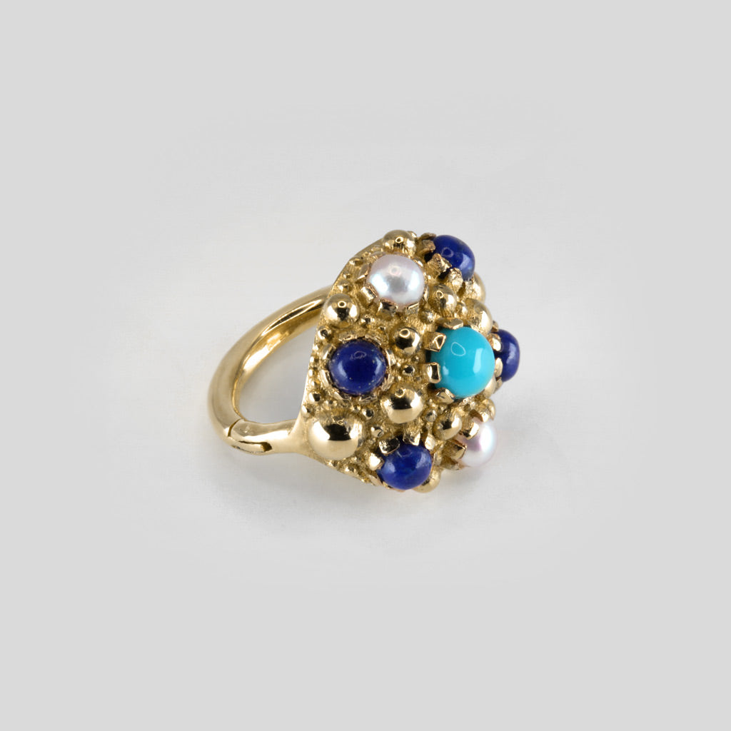Large piercing ring set with several gemstones in 18k yellow gold
