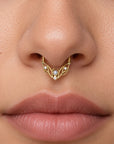 18k gold septum ring with pearls and diamonds on a woman's nose