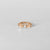 Close-up of Anneau Baya hoop piercing in 18k rose gold, minimalist and elegant design