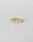 Detail of Anneau Baya hoop piercing, sleek yellow gold finish handmade in Paris