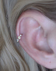 Close-up of a woman with Anneau Baya ring piercing in 18k white gold, handcrafted in Paris