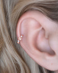 Rose gold ear cuff with floral design and clear stones, elegant piercing jewelry for women