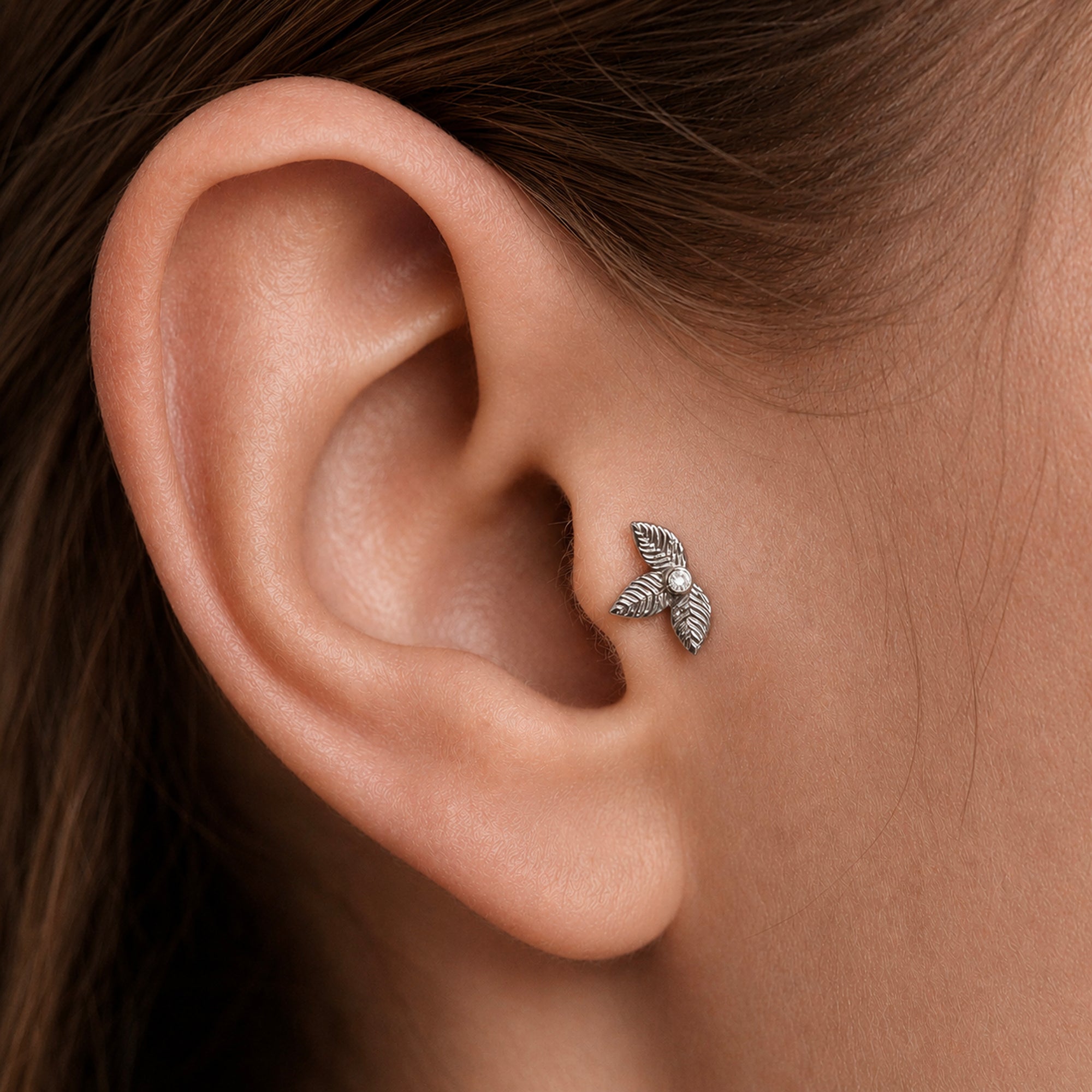 Delicate leaf-shaped ear piercing jewelry with diamond accent, crafted in 18k gold for elegant style.
