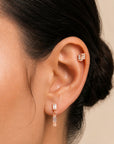 18k gold ear piercing jewelry with baguette and diamond accents, elegant luxury body jewelry for women
