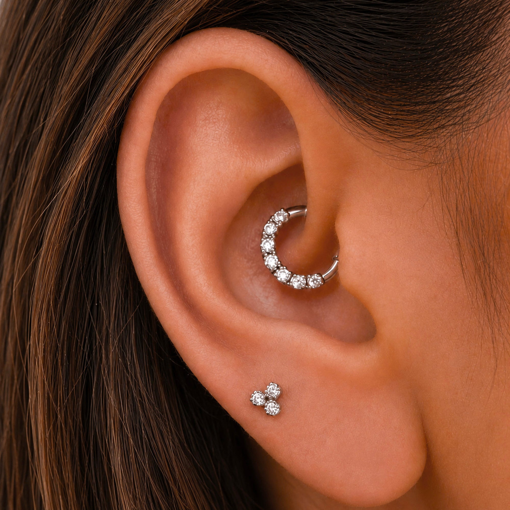 18k gold ear piercing jewelry with diamonds, featuring a huggie hoop and triple stud for elegant ear styling