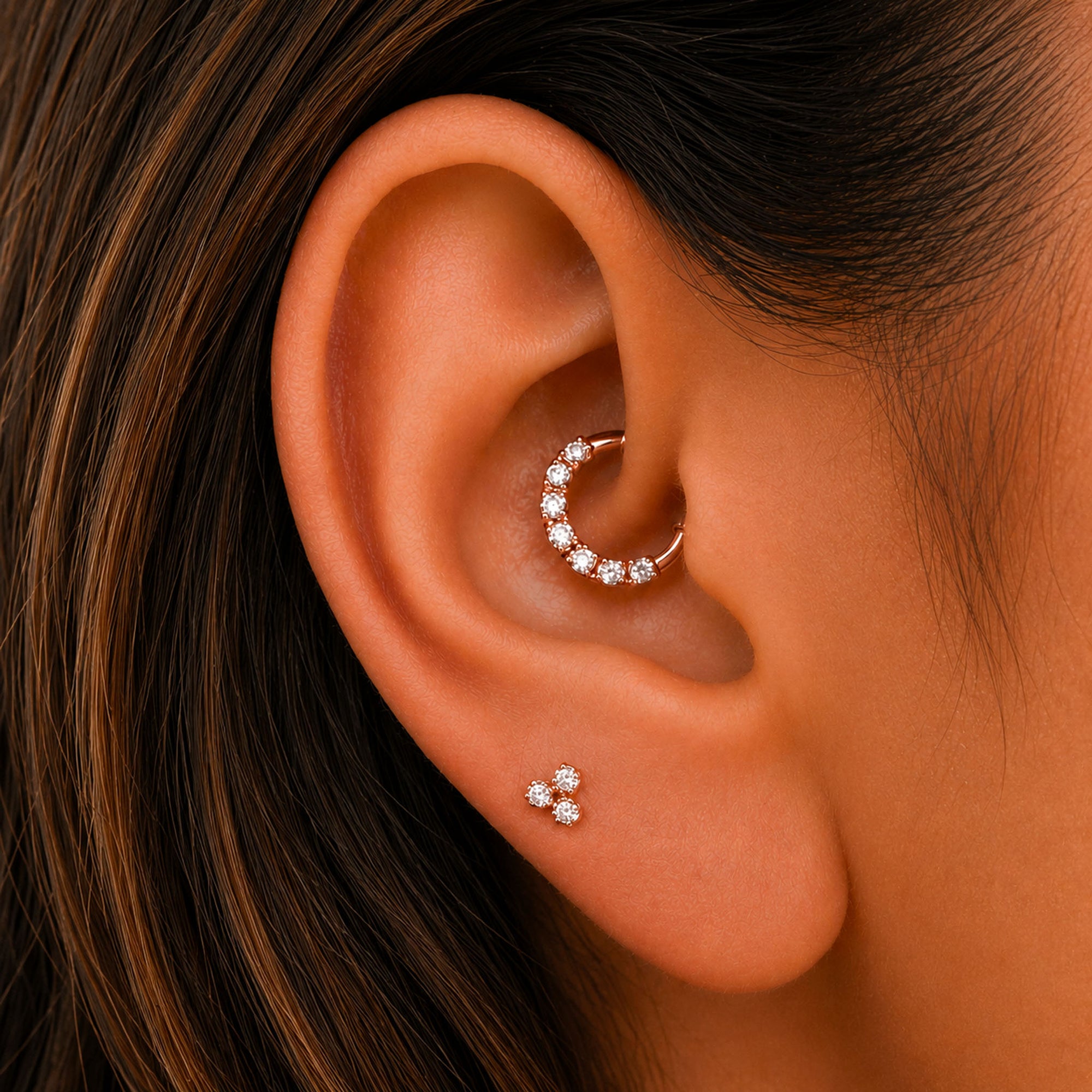 Rose gold ear piercing jewelry with diamond accents, featuring a hoop and stud set for elegant ear styling.