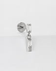 Silver barbell earring with two rectangular crystals on white background