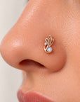Elegant 18k gold nose stud with a pearl and diamond in a swirling leaf design