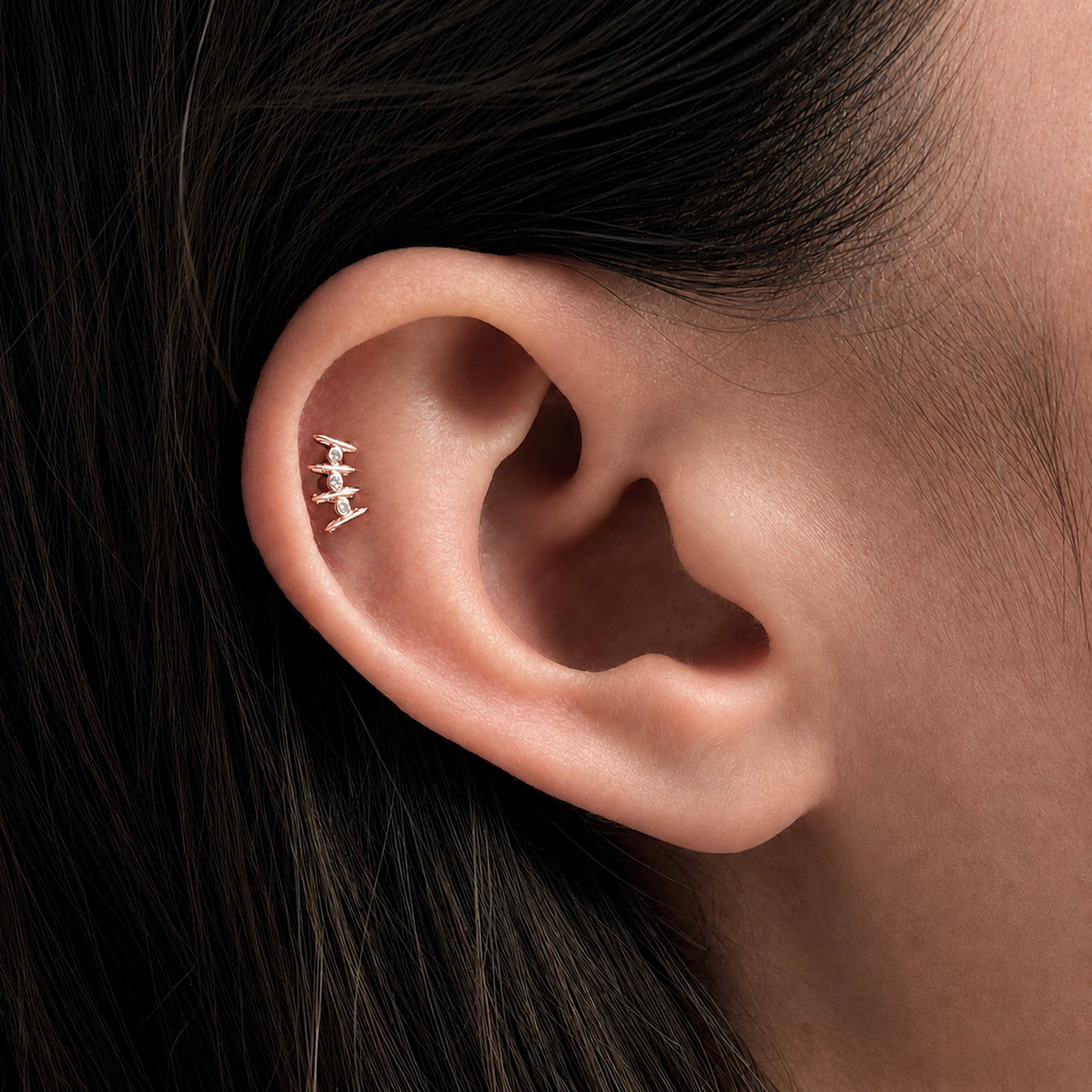 Elegant 18k gold ear piercing with diamonds, showcasing luxury body jewelry for a timeless style.