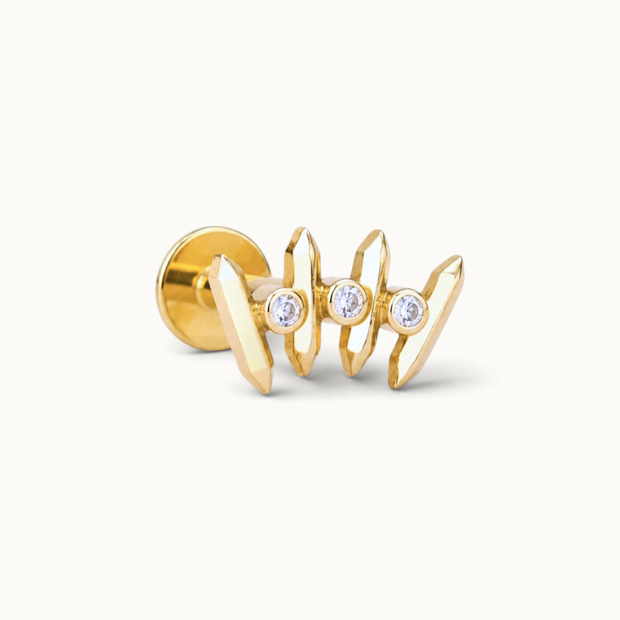 18k gold piercing jewelry with three diamonds and geometric design
