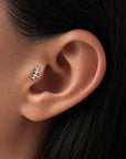Delicate 18k gold ear piercing with diamond accents, elegant helix jewelry for minimalist style