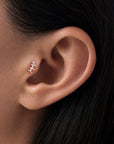 Elegant rose gold ear piercing with diamonds, showcasing luxury body jewelry for a refined look.