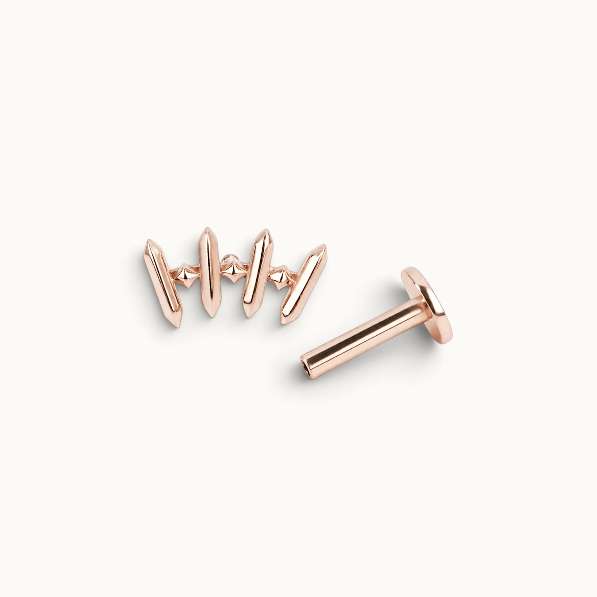 Rose gold piercing jewelry with geometric spikes and tiny stones, handmade luxury body adornment