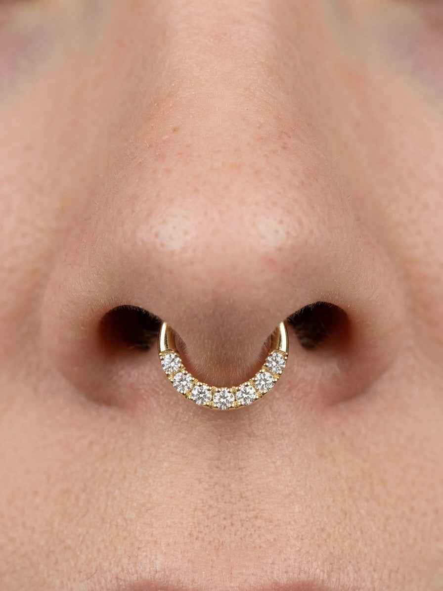 18k gold septum piercing with pave set sparkling white stones on nose