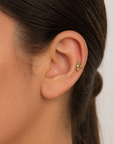 18k gold leaf cartilage earring with diamond on woman's ear