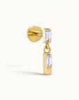 18k gold ear piercing with dangling emerald-cut stones, luxury body jewelry for elegant style