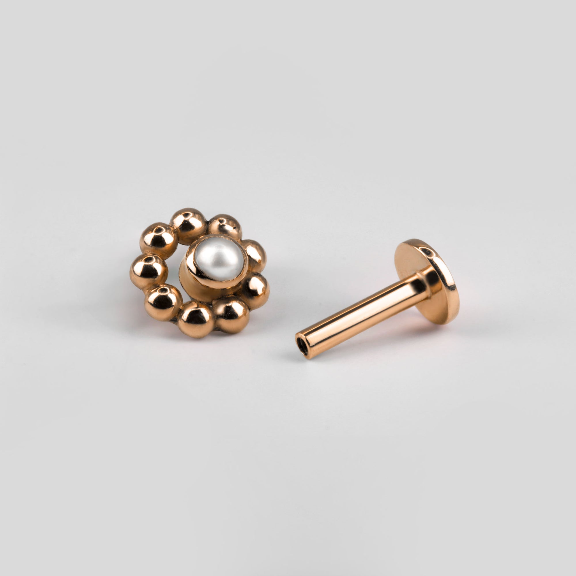 Circular beaded ear piercing in 18k rose gold with pearl
