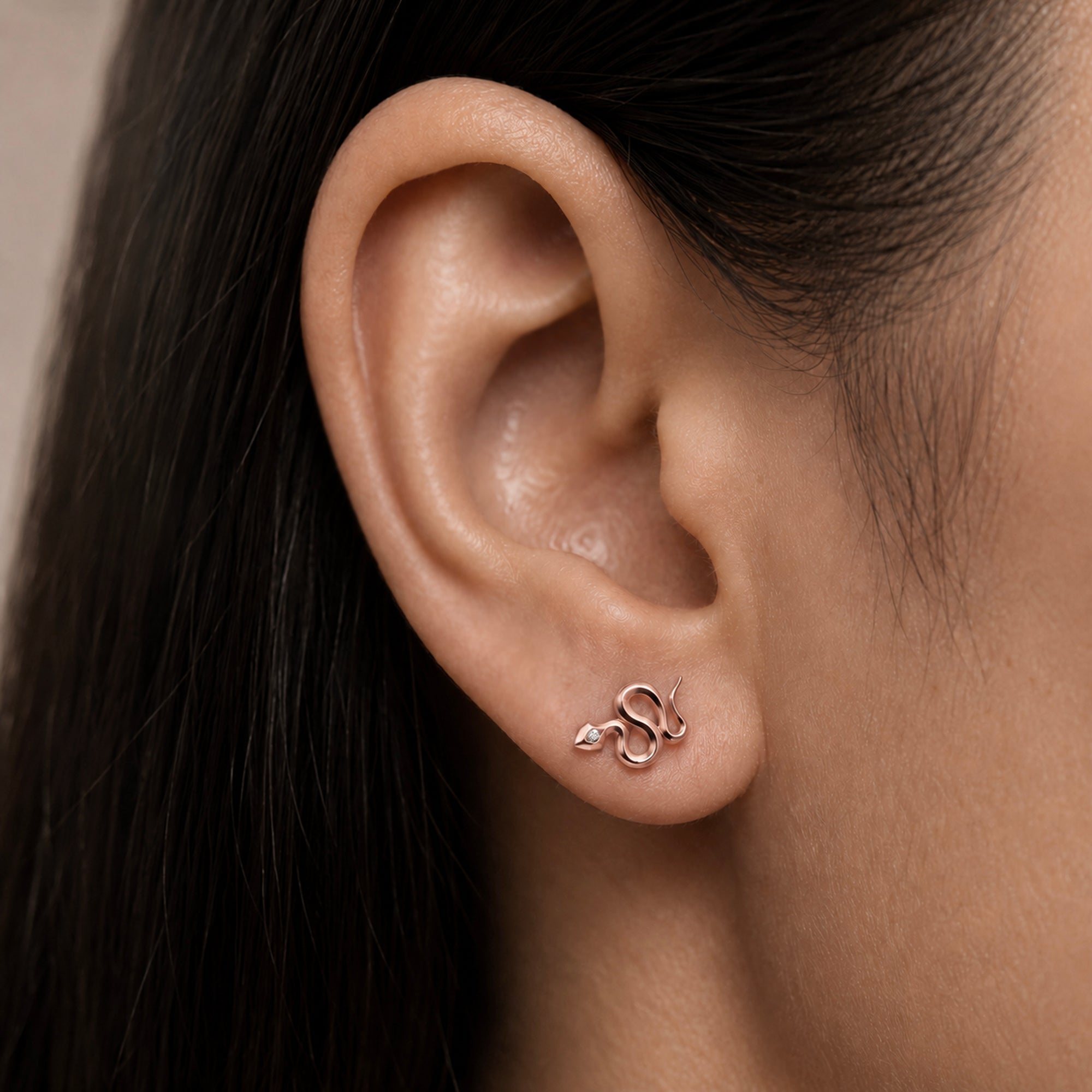 Rose gold snake ear piercing with diamond eye, luxury 18k gold body jewelry for elegant style