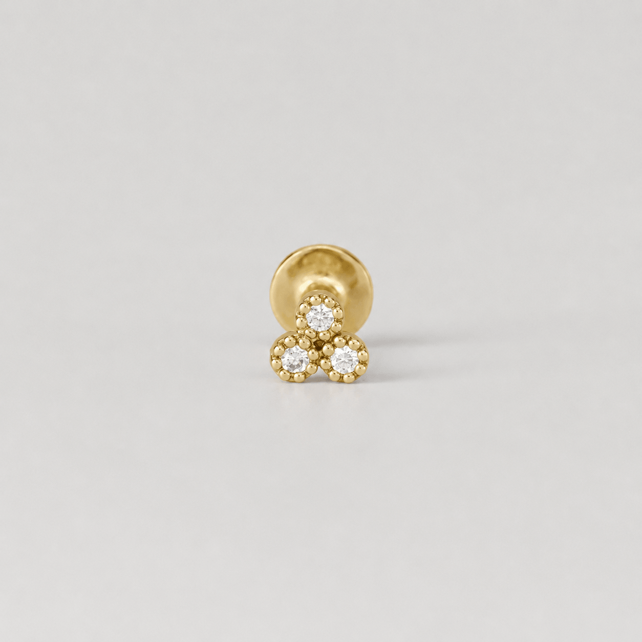 18k gold piercing earring with three diamond accents, luxury body jewelry