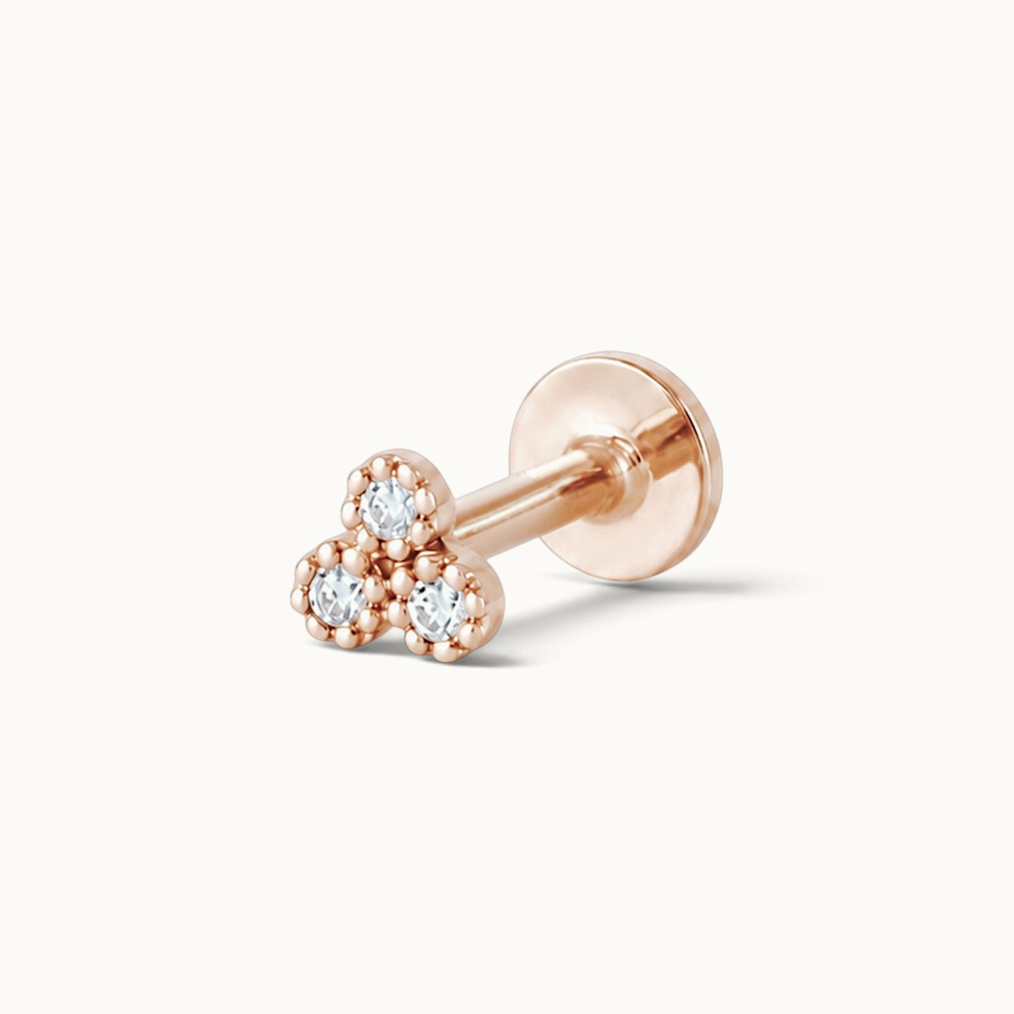 18k rose gold stud earring with three diamond-like stones in floral design, luxury piercing jewelry