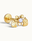 18k gold piercing stud with an ornate wing design and a central white pearl