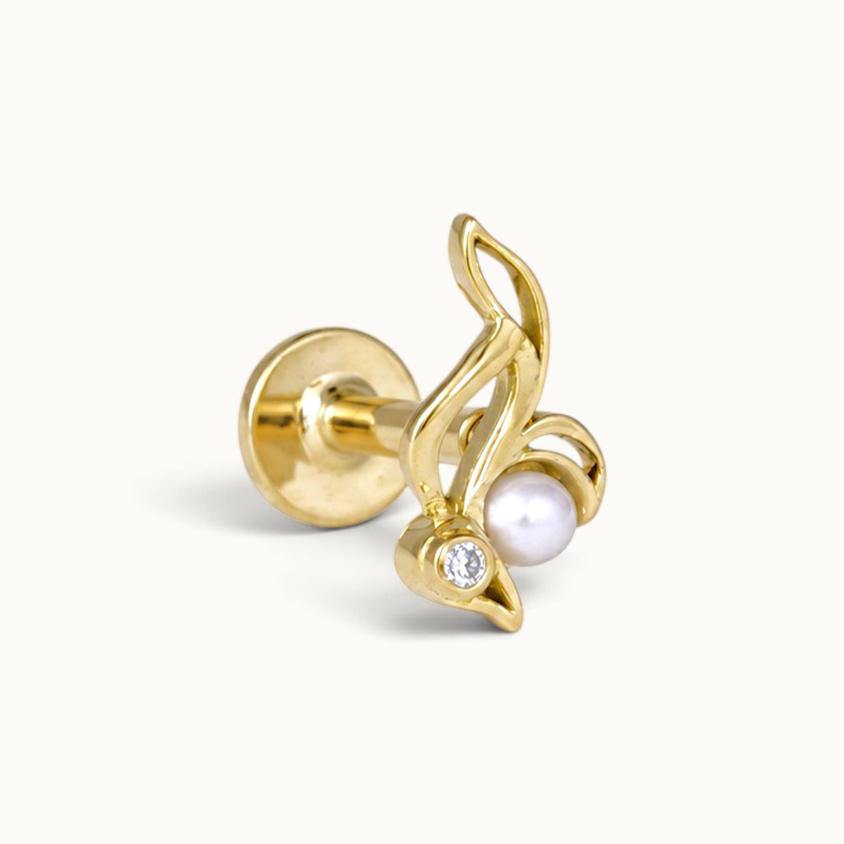 18k gold piercing stud featuring a pearl and diamond in a curved leaf design