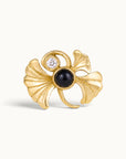 18k gold ginkgo leaf piercing jewelry with a black gemstone and diamond
