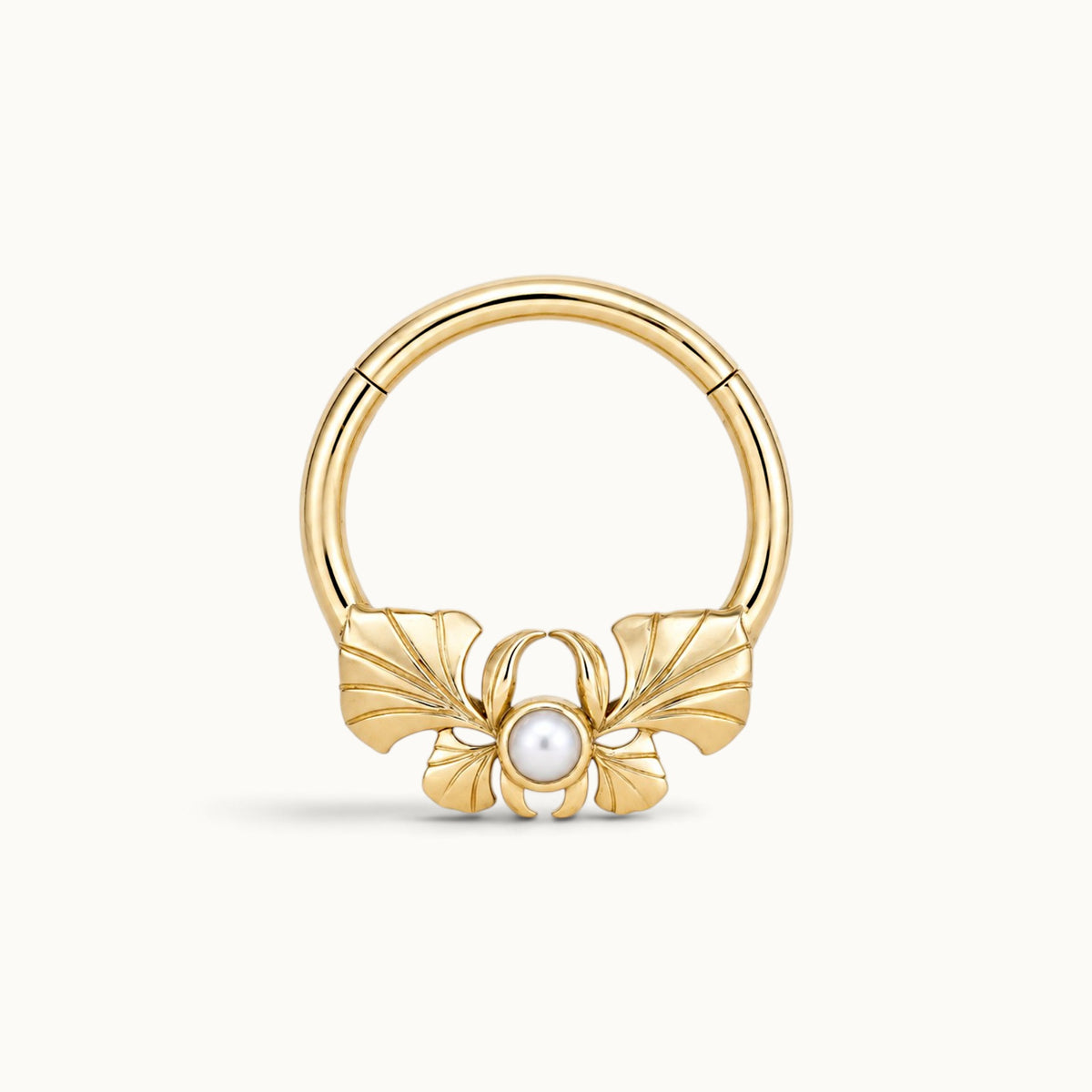 18k gold clicker hoop piercing with a pearl and ginkgo leaf design