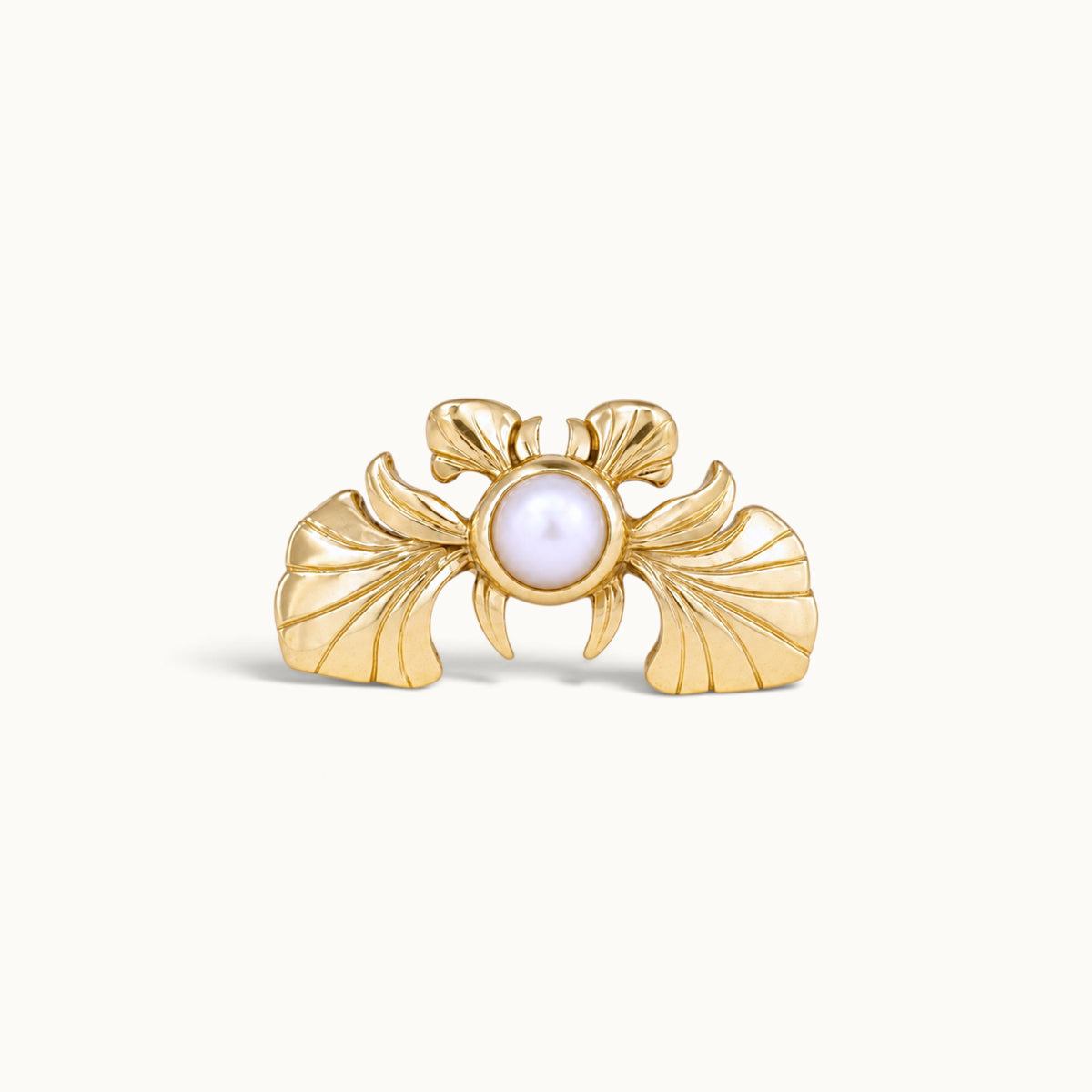 18k gold piercing jewelry featuring a central pearl and ornate wing-like gold details