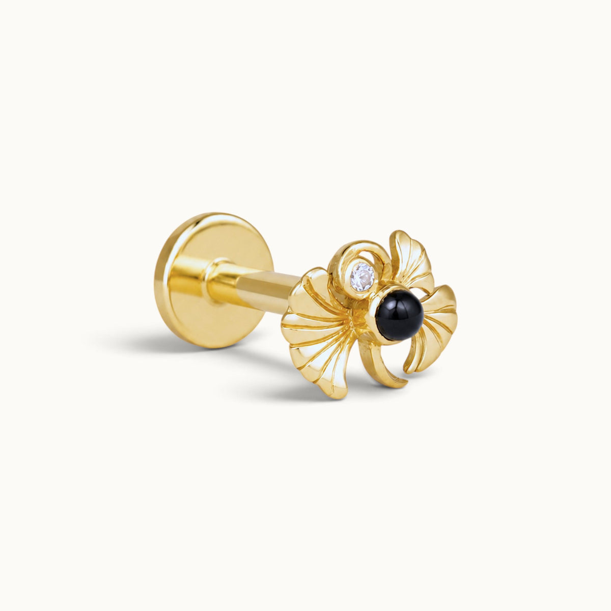 18k gold piercing stud with a decorative black stone and diamond accent