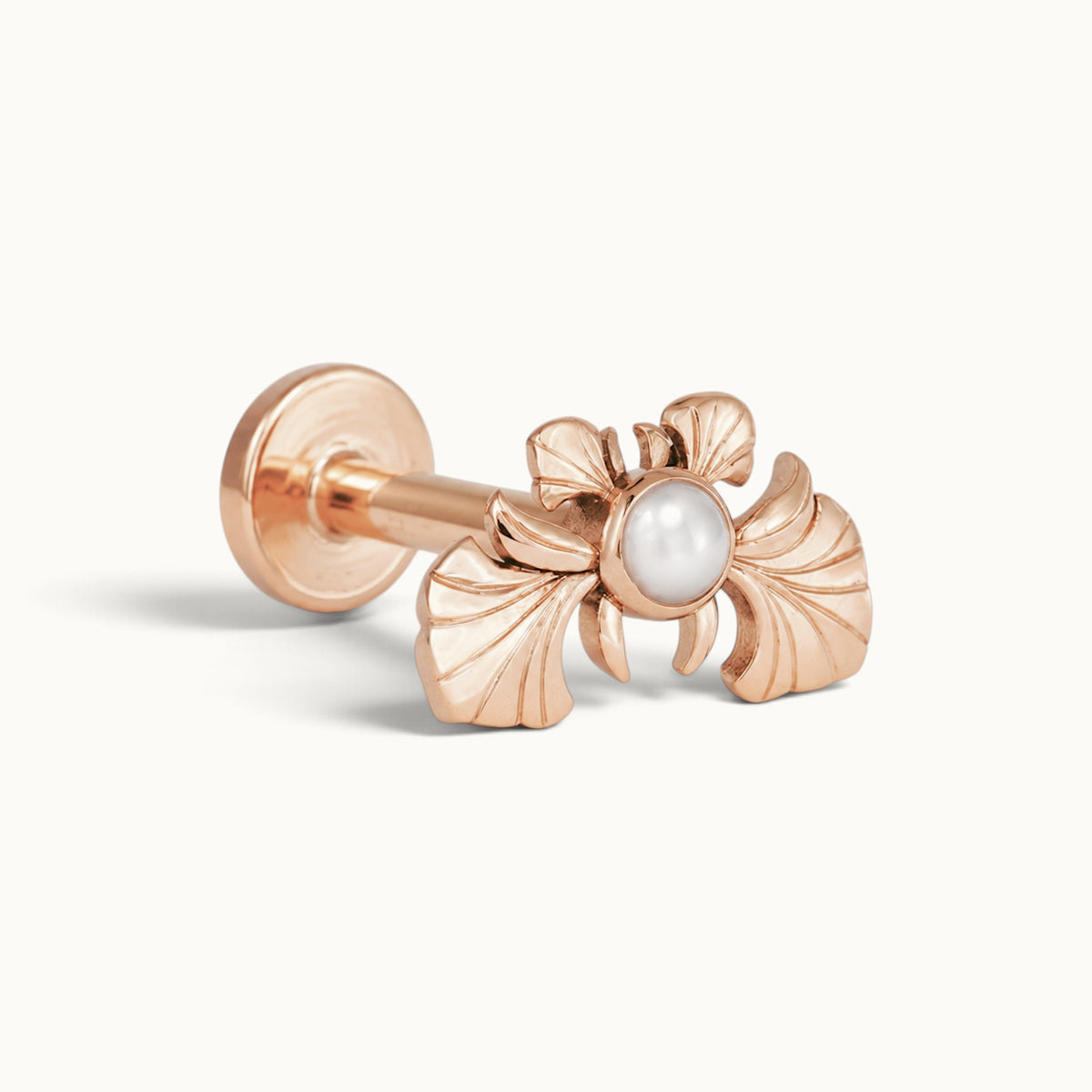 Rose gold ginkgo leaf piercing stud with a central white pearl