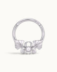 Silver hoop piercing jewelry with a decorative bow and a central pearl