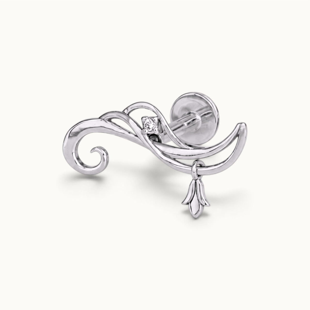 Elegant white gold swirl cartilage piercing with a small diamond and floral charm