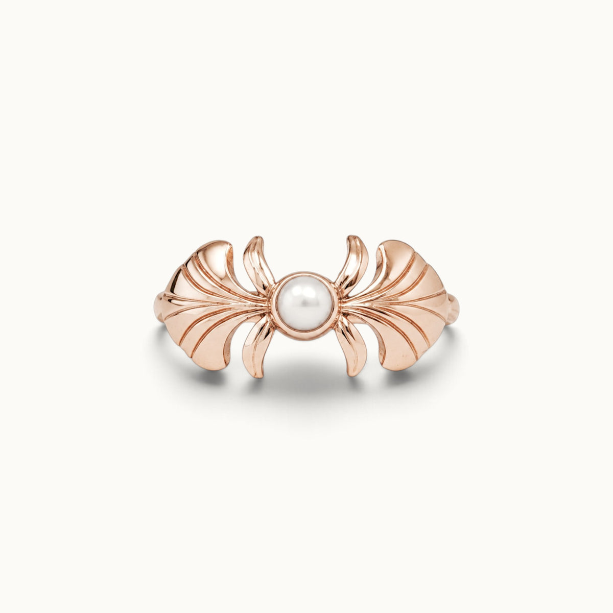 Rose gold sculpted ring with a central white pearl