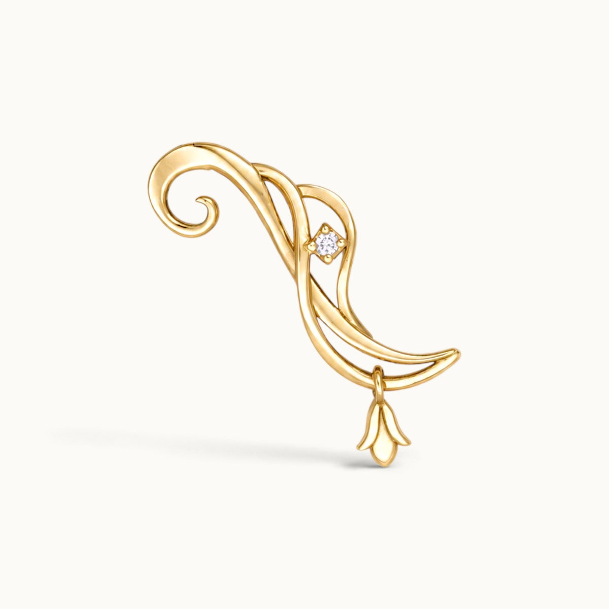 18k gold swirling ear climber piercing jewelry with a small diamond and floral charm