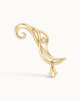 18k gold swirling ear climber piercing jewelry with a small diamond and floral charm