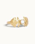 Handmade 18k gold ring with a central pearl and ornate wing-like designs