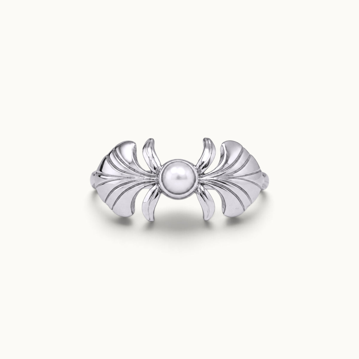 Silver sculptural ring with a central pearl and wing-like motifs