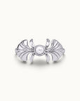 Silver sculptural ring with a central pearl and wing-like motifs