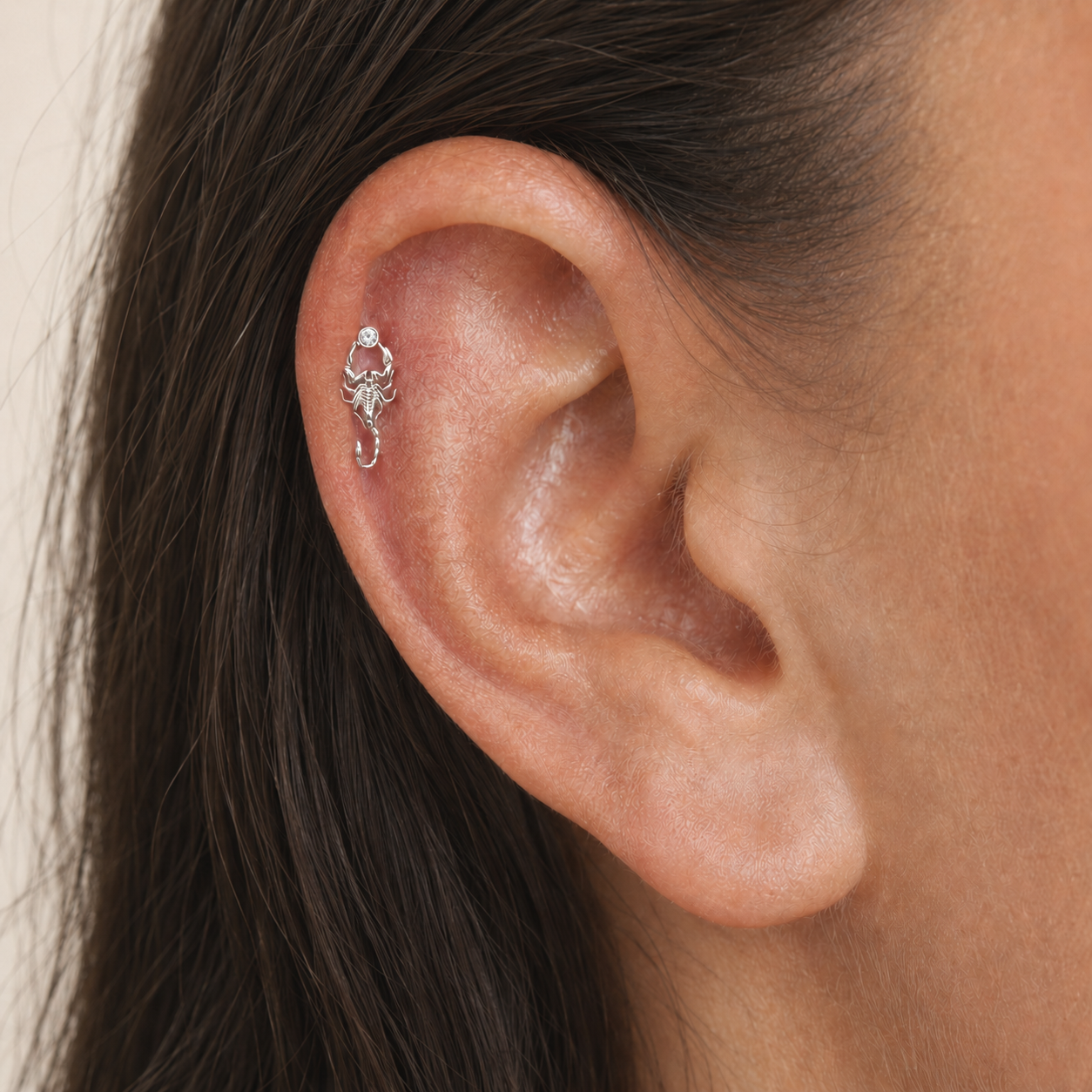 Delicate scorpion ear piercing in 18k gold with diamond accent, luxury body jewelry for elegant style.